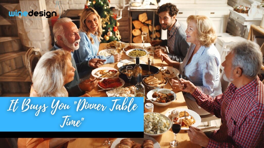 Group of people at a dinner party with a custom labelled wine bottle in the centre of the table