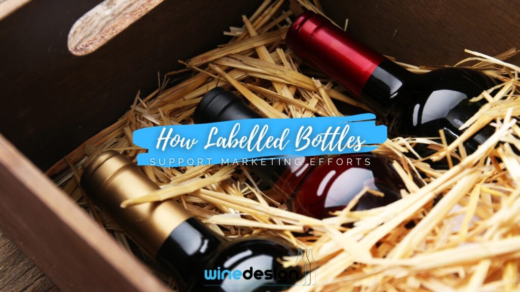 Three bottles of red wine with custom corporate branding labels standing on a wooden table