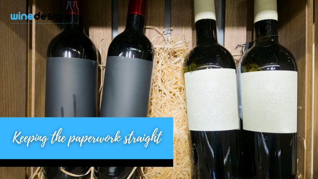 Branded Wine Bottles That Keep Clients Connected - Bottles Four wine bottles lined up side-by-side in a wooden crate with straw packing material.