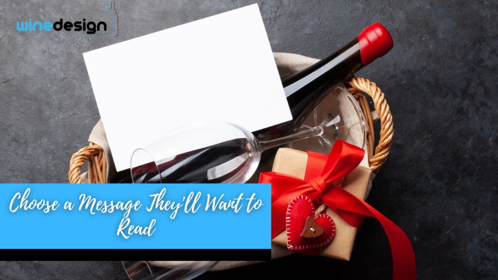 A wine gift basket with a bottle of red wine label, two wine glasses, a wrapped gift box, and a blank card.